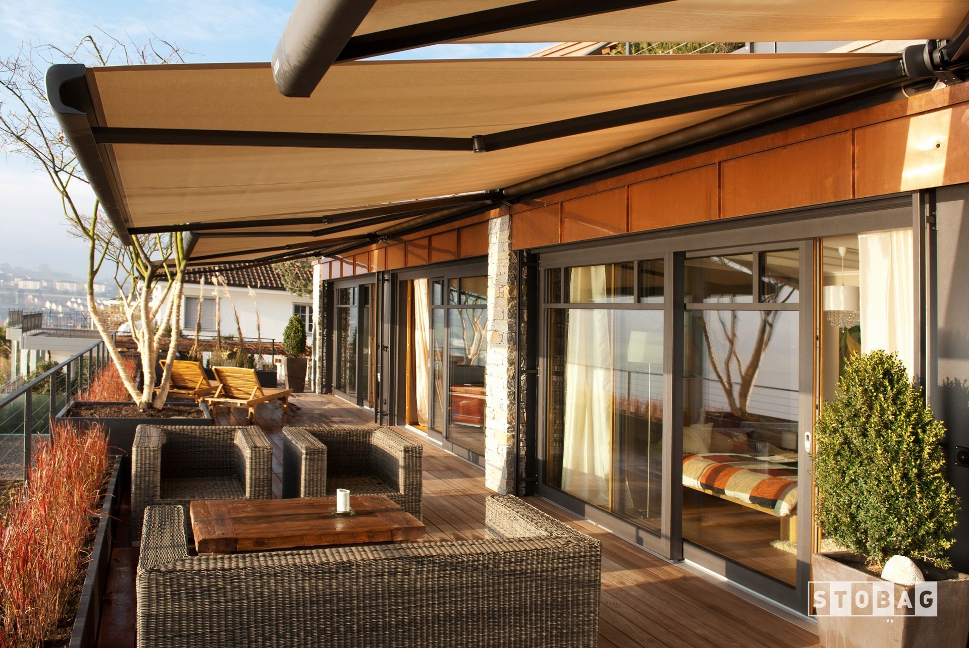 A kitchen with white cabinets and shutters on the windows