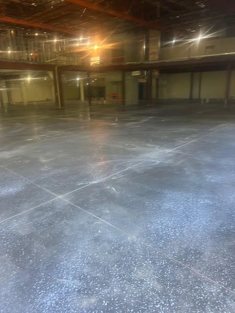 A large empty warehouse with a concrete floor.