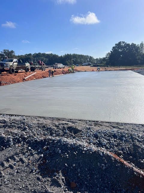 A concrete driveway leading to a house with a garage.