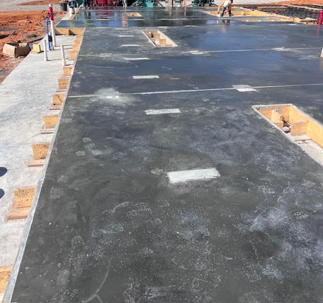 A concrete floor with a few holes in it