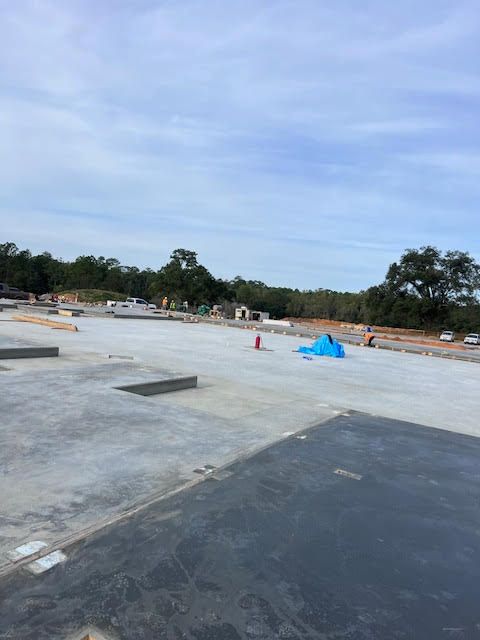 A construction site with a blue tarp on the ground.