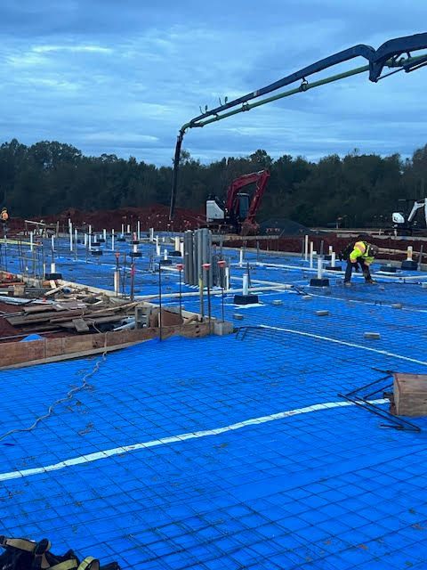 A construction site with a blue tarp on the ground.