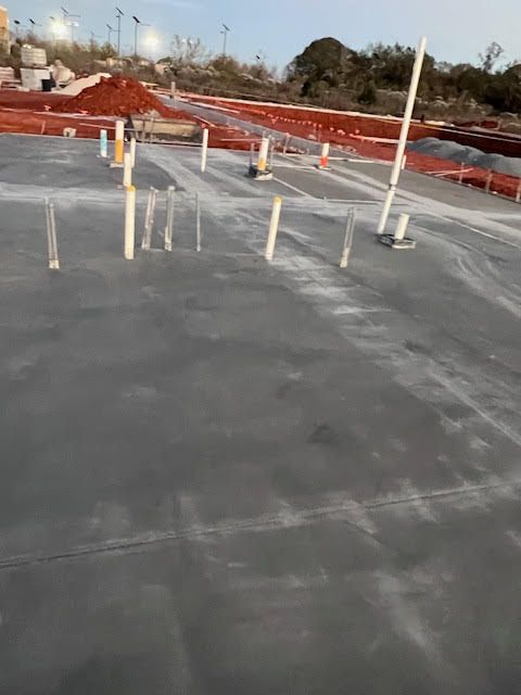 A concrete floor with a lot of pipes on it