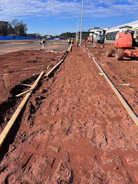 A construction site with a tractor in the background