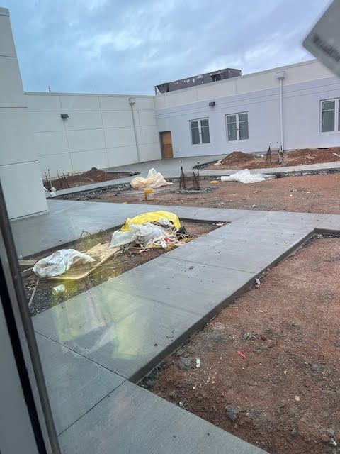 A view of a building under construction from a window.