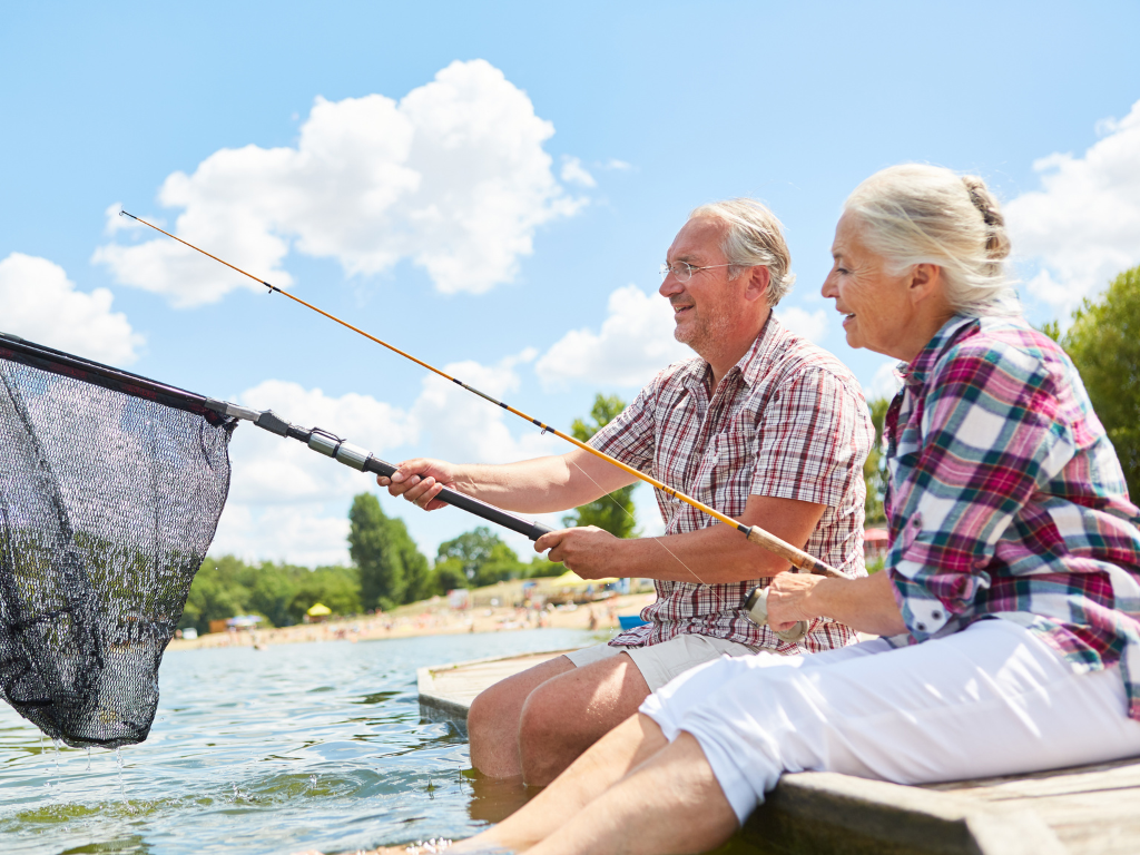 Smiling older couple fishing — St Michael, MN — EMEX Benefits Systems