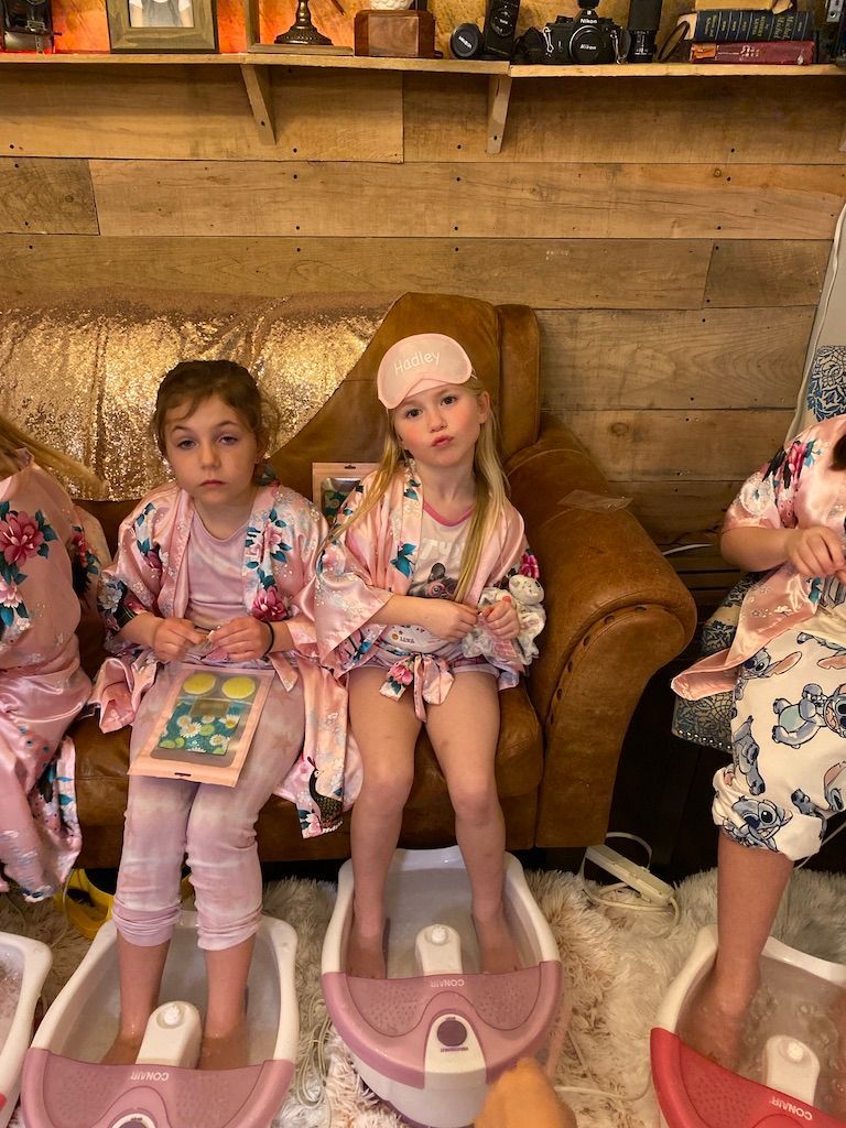 adorable little girls in flower robes enjoying a spa party