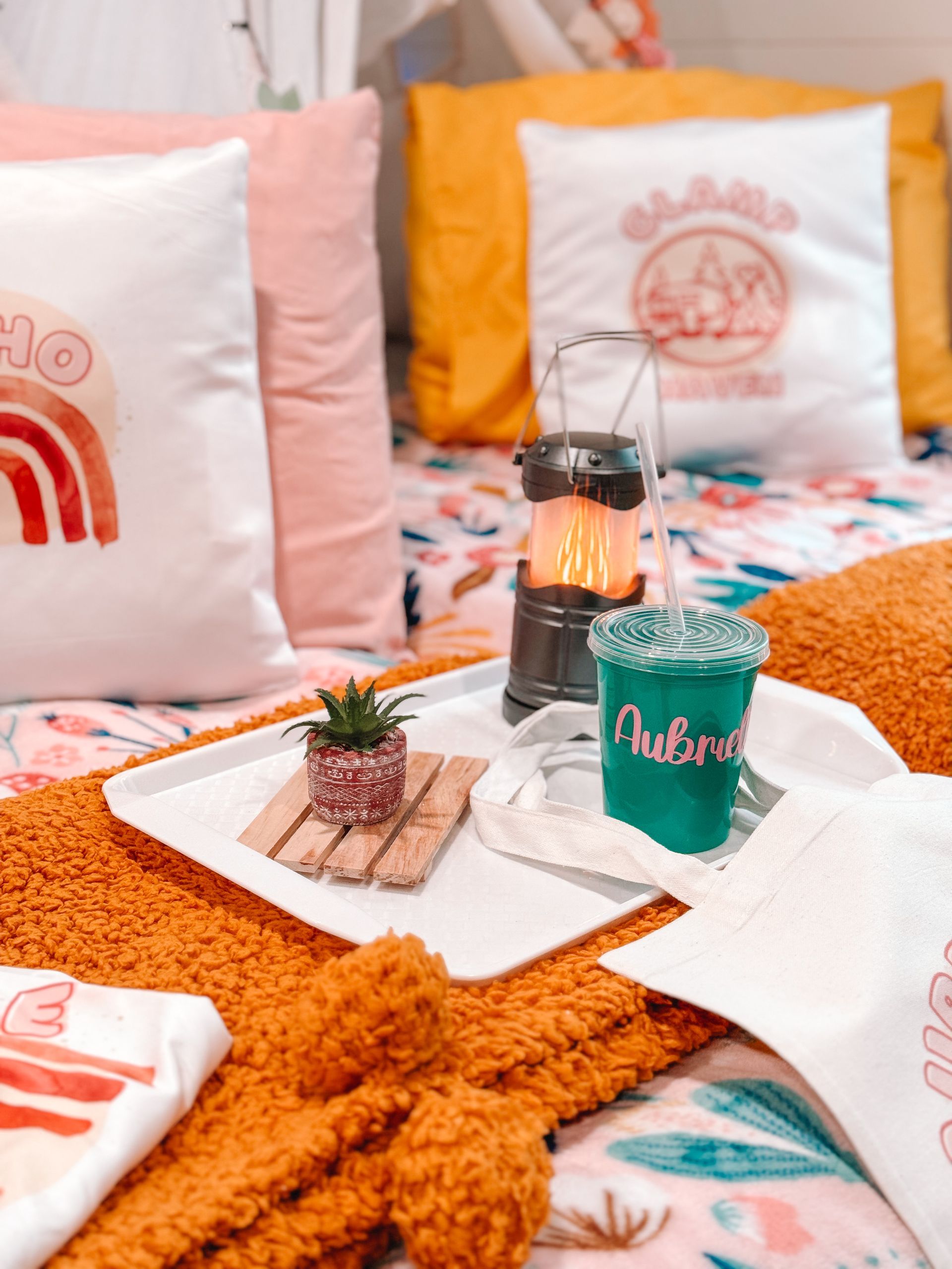 A bed with a tray of food and a drink on it.