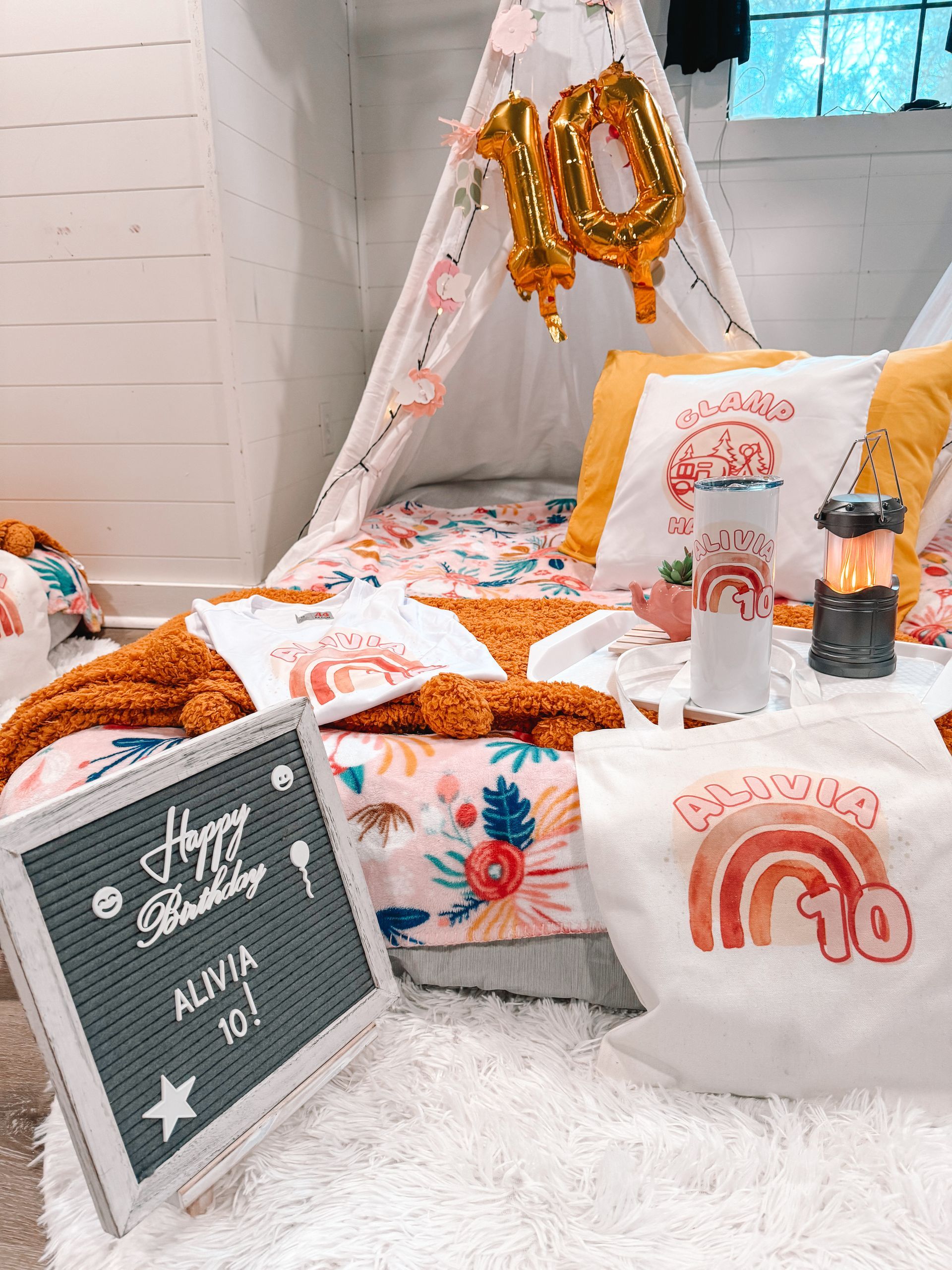 A bed with a teepee and a sign that says `` happy birthday ''.