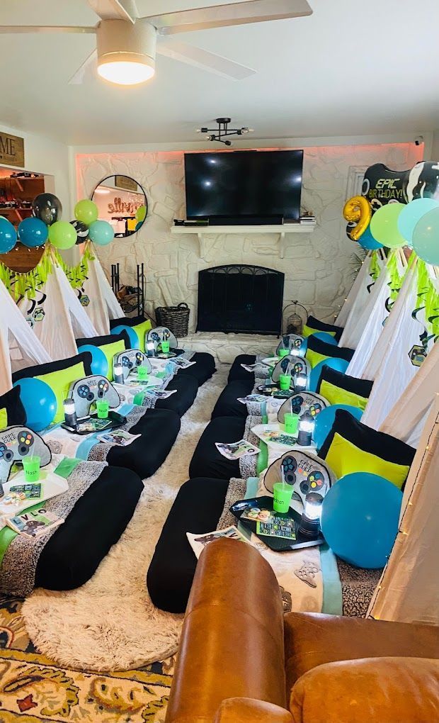 A living room decorated for a party with tents and balloons.