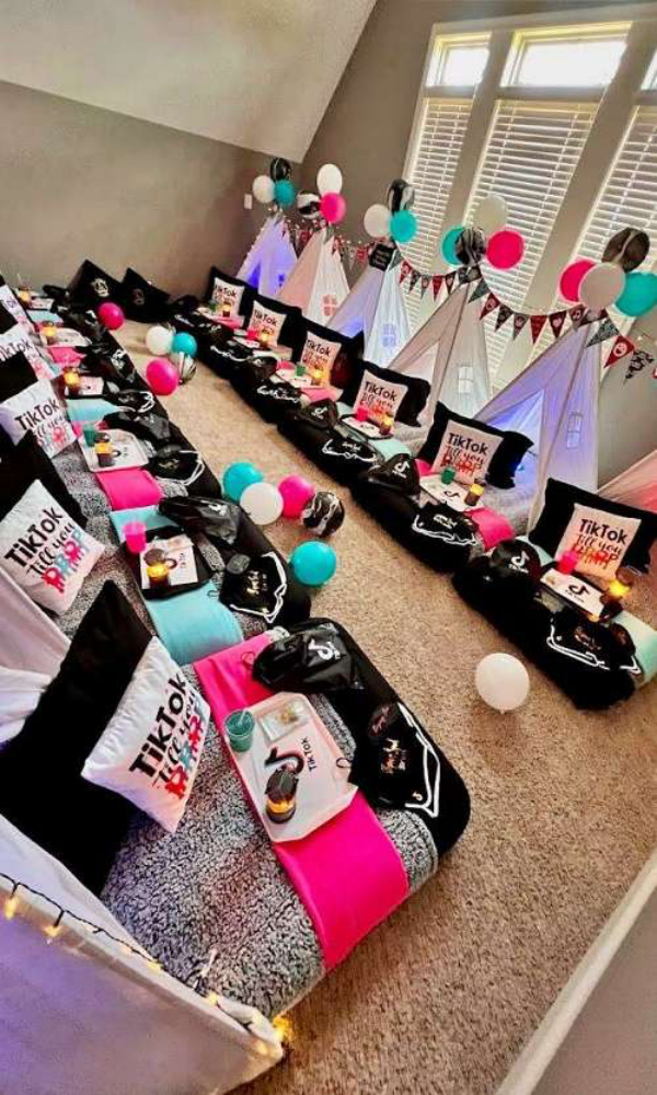 A room decorated for a sleepover with tents and pillows.