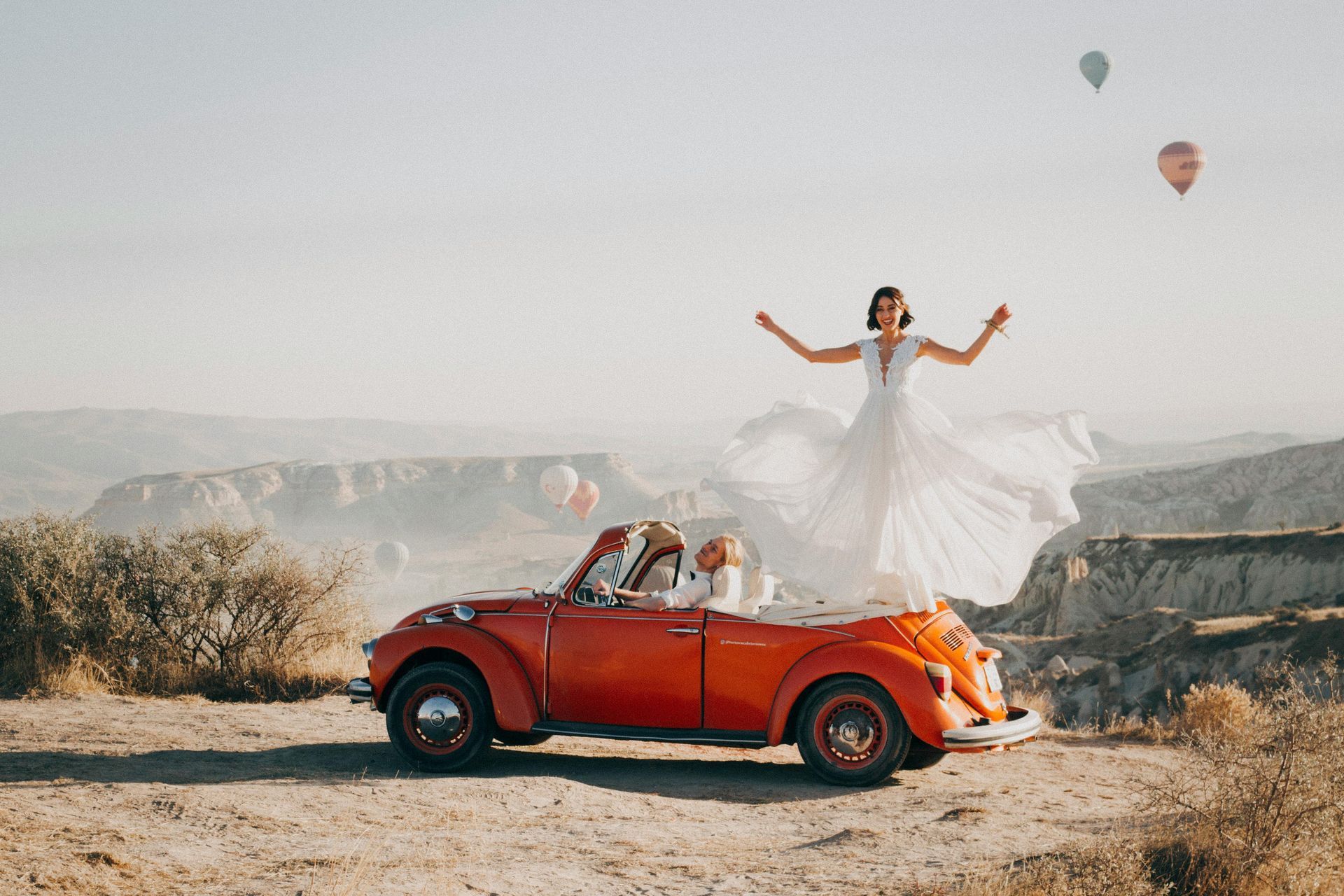 bride standing on a car