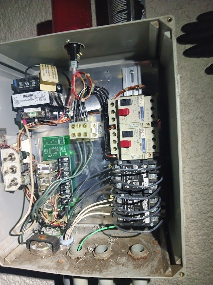 The inside of an electrical box with a lot of wires