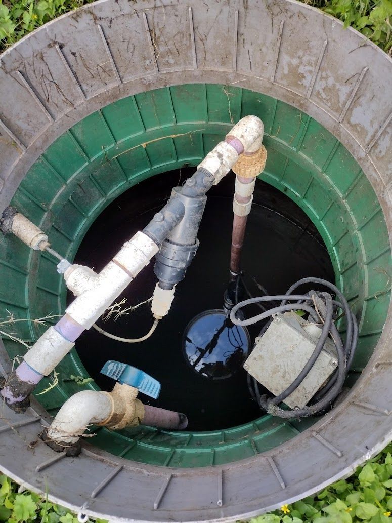 A manhole cover with pipes and a pump in it