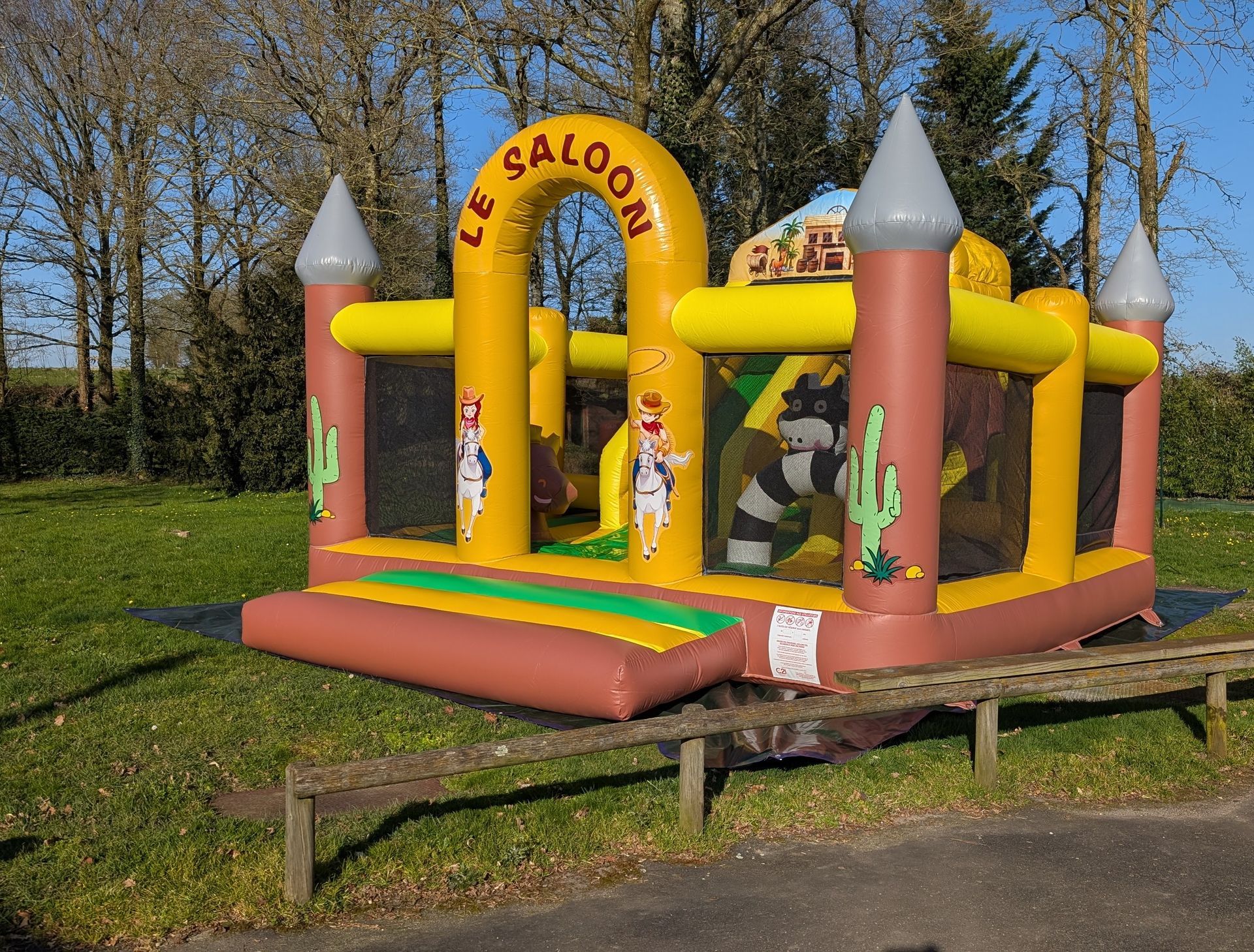 Un château gonflable avec un château et des cactus dessus