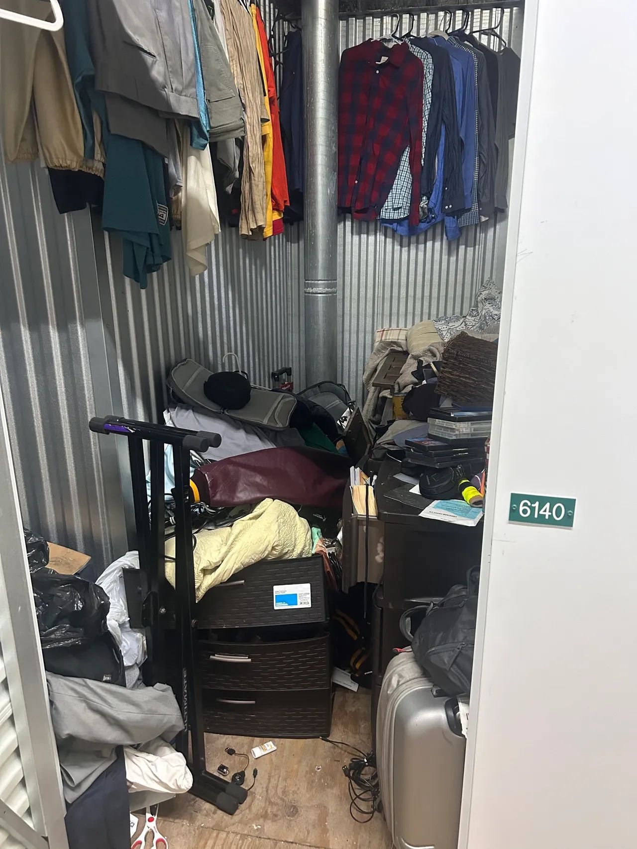 A room filled with lots of clothes and luggage.