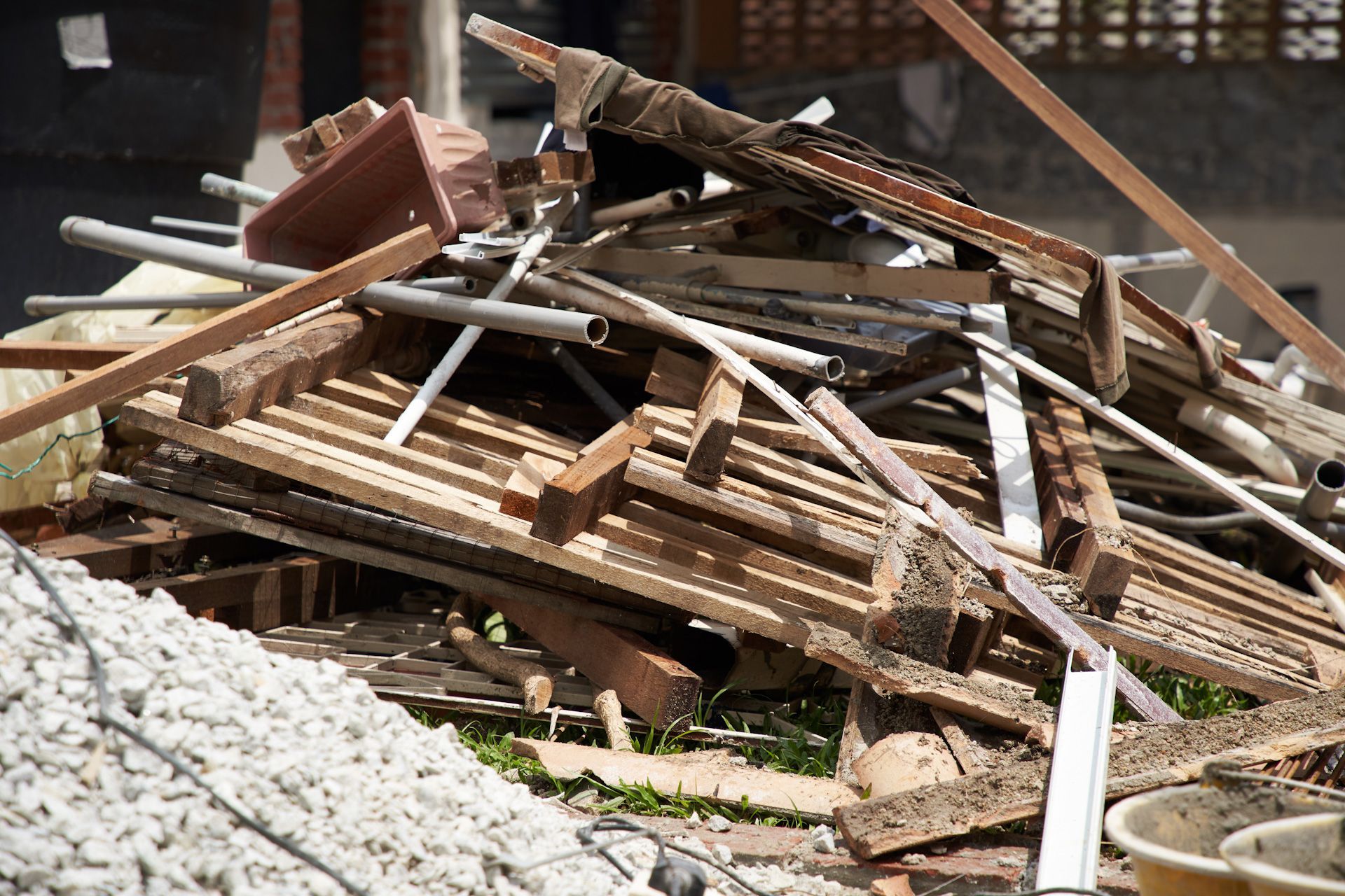 A pile of wood and metal is sitting on top of a pile of gravel.