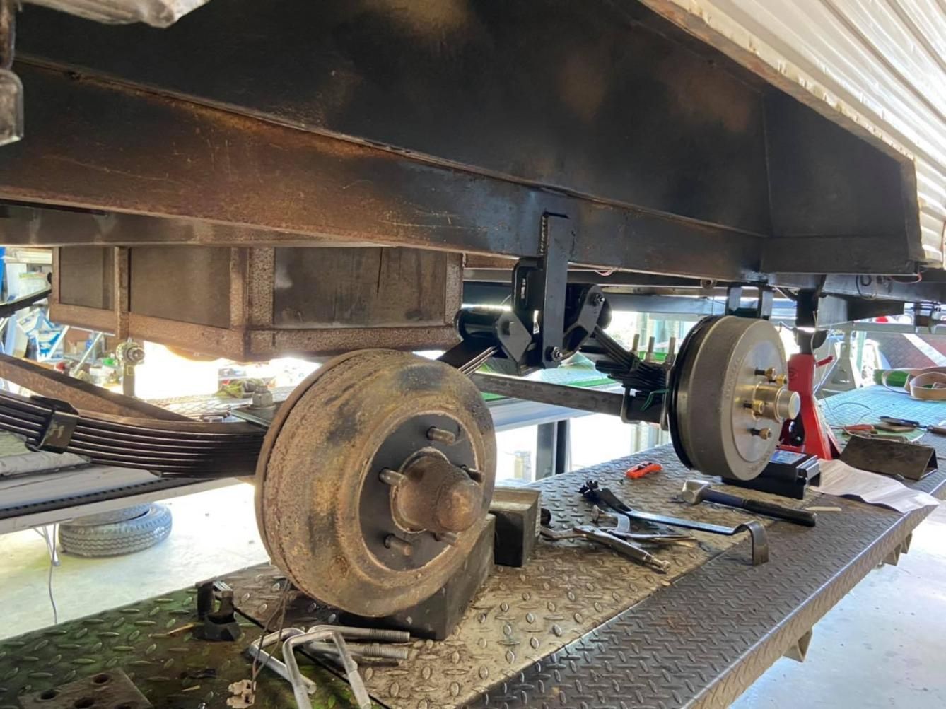 A Trailer is Being Repaired on a Table in a Garage — J & D Caravans In Tamaree, QLD