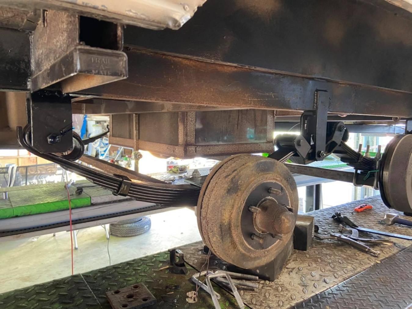 The Rear Suspension of a Trailer is Being Repaired — J & D Caravans In Cooloola, QLD