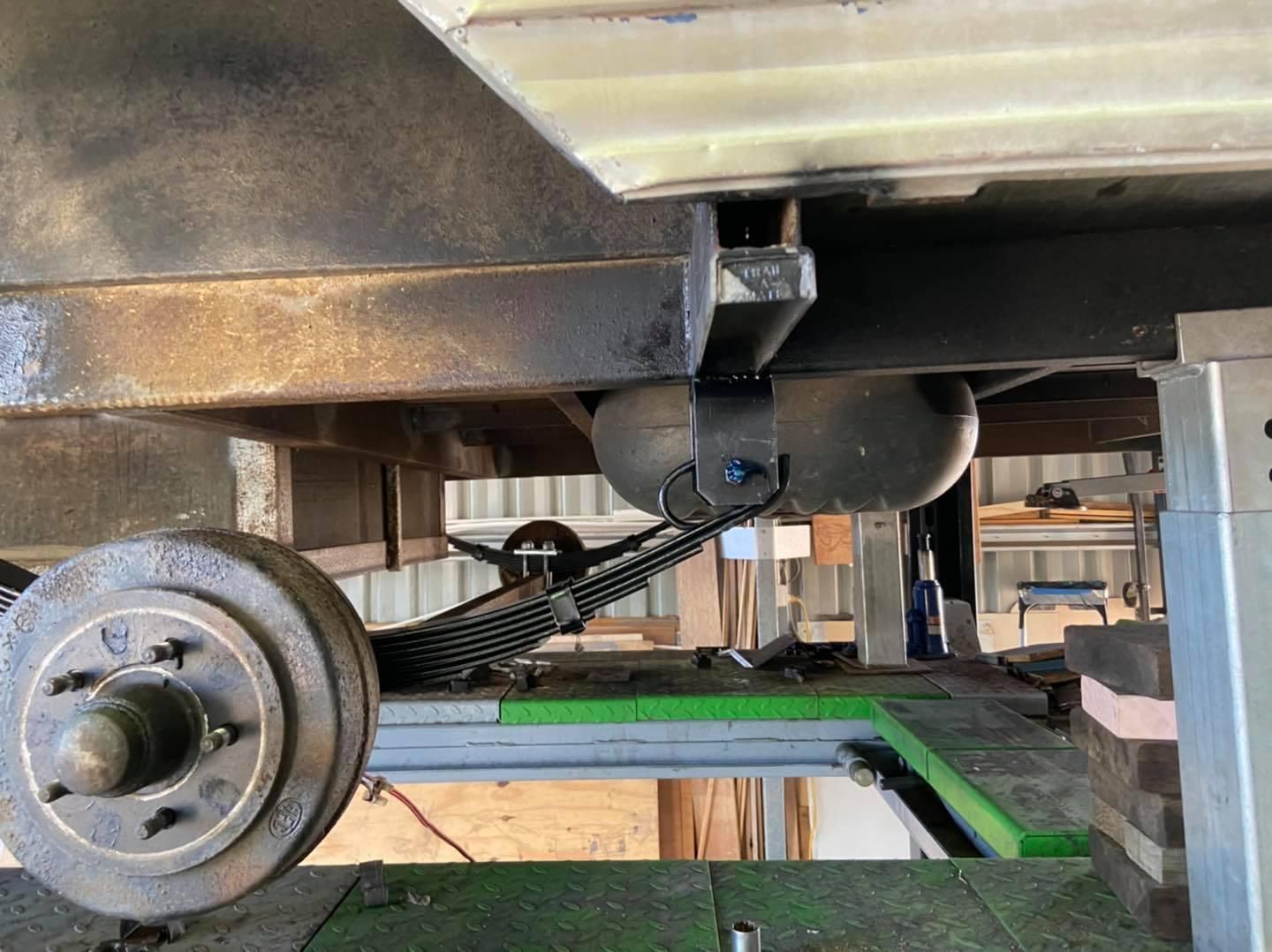 A Car is Sitting on a Lift in a Garage — J & D Caravans In Cooloola, QLD