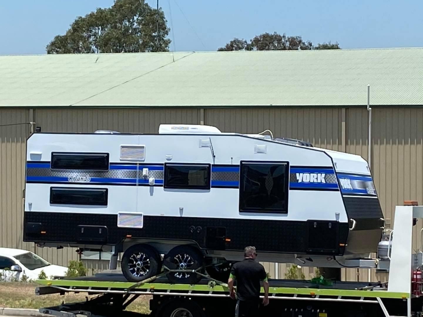 A York Trailer is Being Towed by a Tow Truck — J & D Caravans In Glenwood, QLD