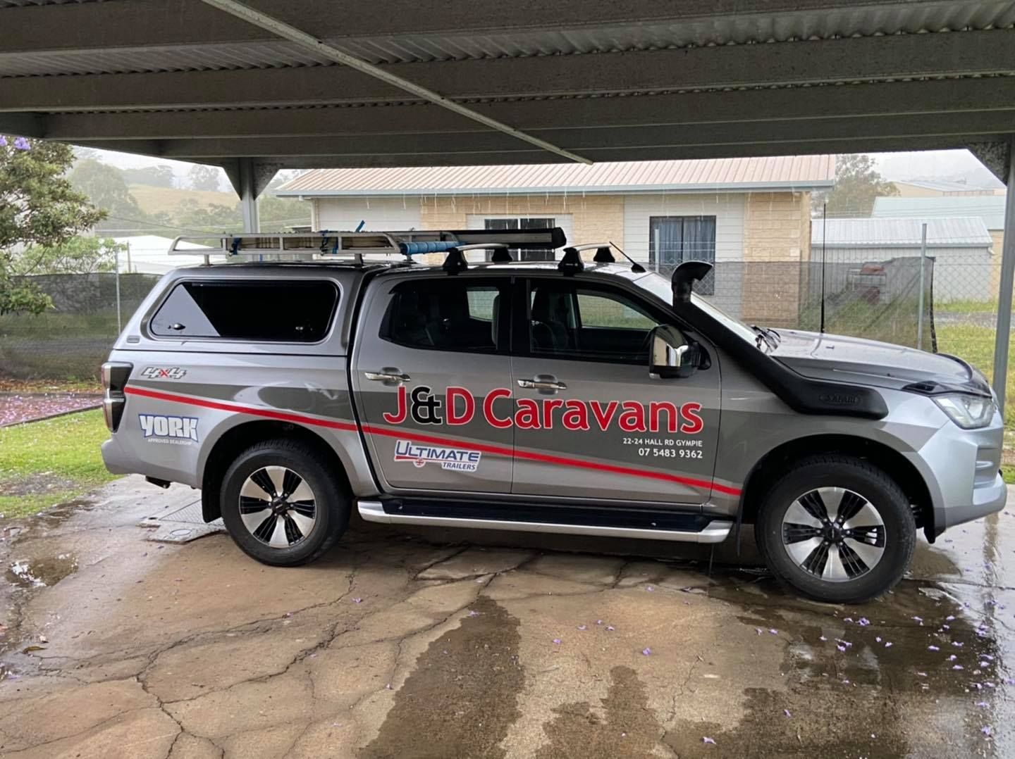 A Truck is Parked Under a Canopy in Front of a House — J & D Caravans In Tamaree, QLD
