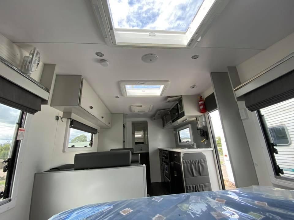 The Inside of a Camper Van With a Bed and a Skylight — J & D Caravans In Tamaree, QLD