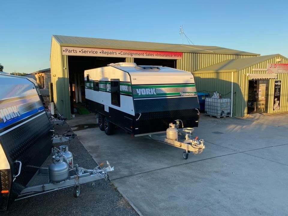 A Trailer is Parked in Front of a Building in a Parking Lot — J & D Caravans In Tamaree, QLD