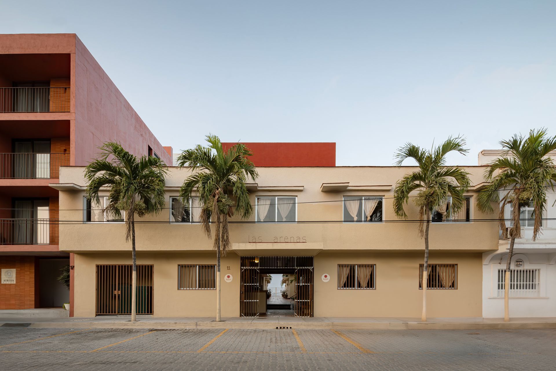 A large building with palm trees in front of it