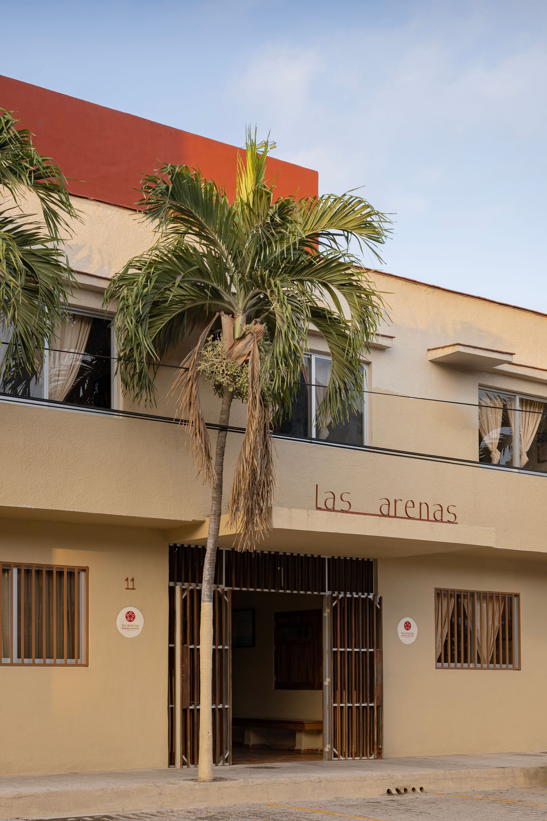 A building with a palm tree in front of it