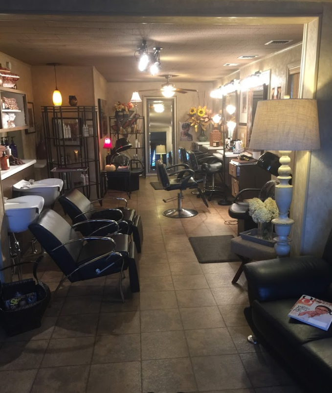 A salon with a lot of chairs and sinks