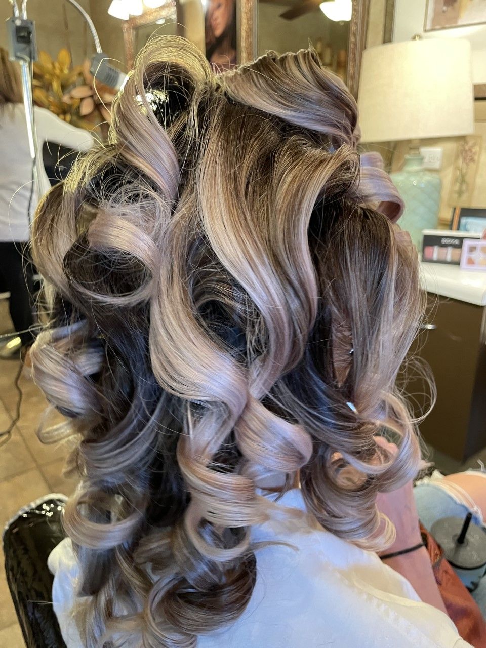 A woman is getting her hair done in a salon.