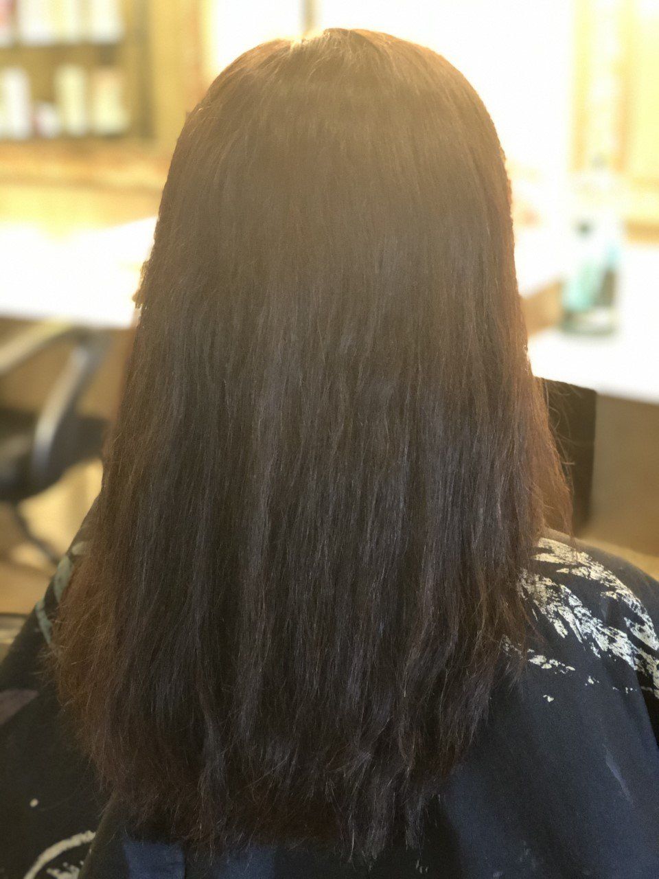 The back of a woman 's head with long dark hair