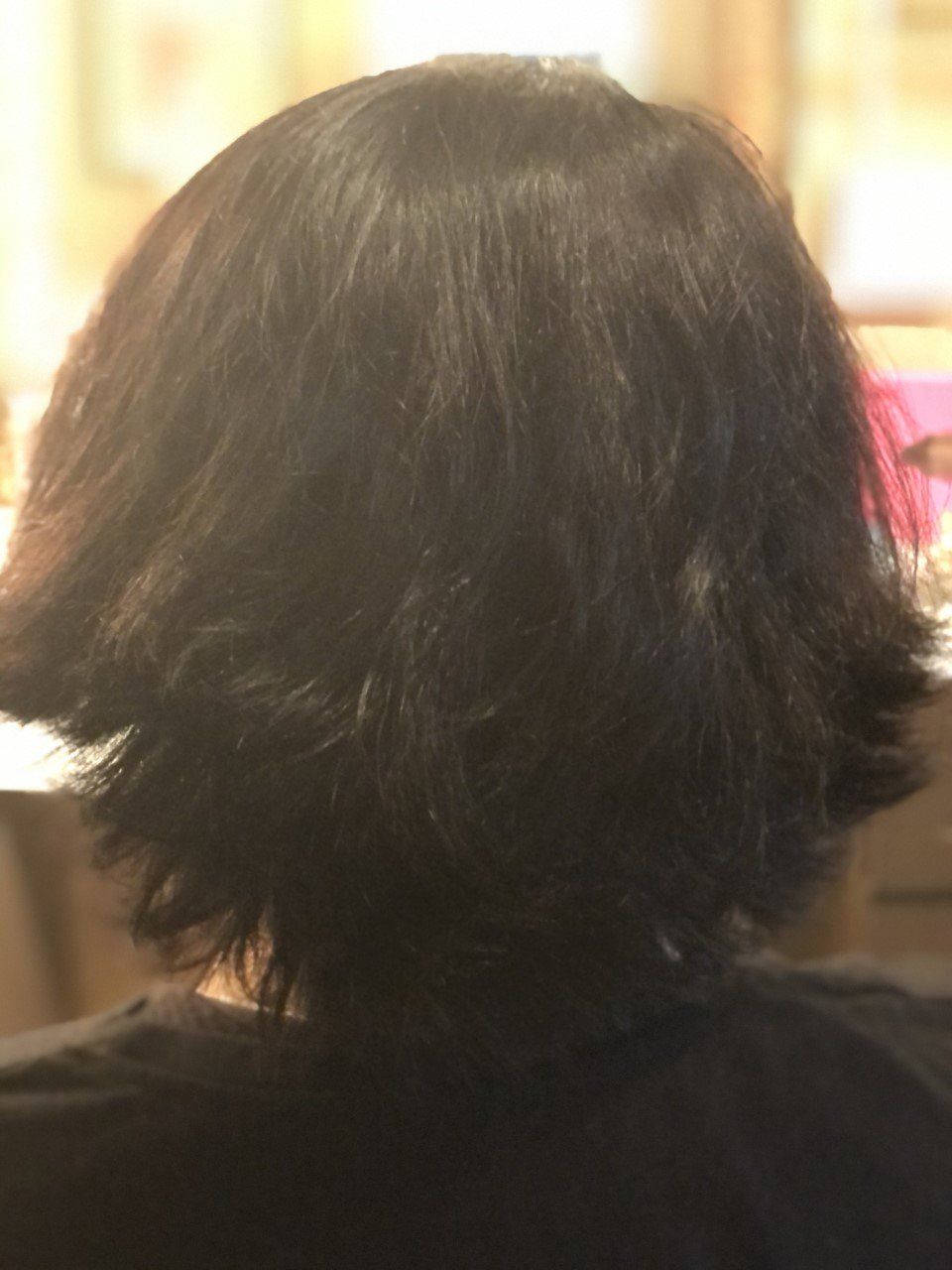 A close up of a person 's hair from the back