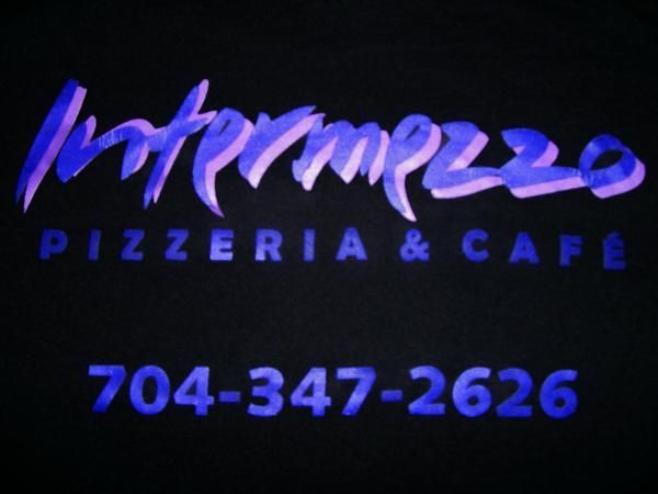 A sign for intermezzo pizzeria and cafe with a phone number