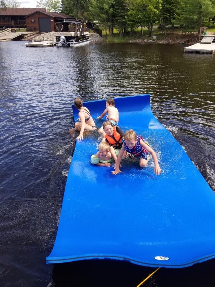 A woman is paddling a kayak on a lake.