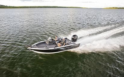 A boat is floating on top of a large body of water.