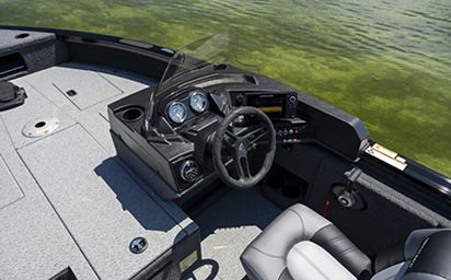 The steering wheel of a boat is sitting in the water.