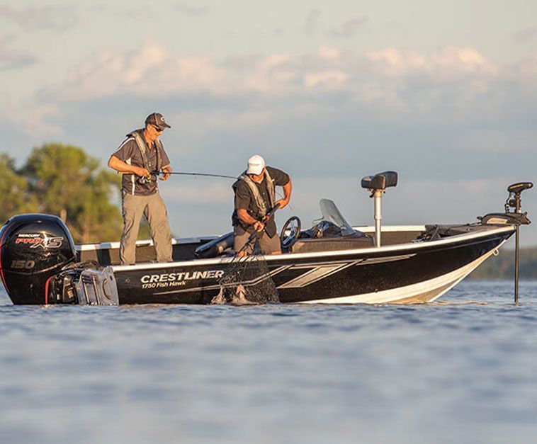 Two men are fishing in a boat on a lake.