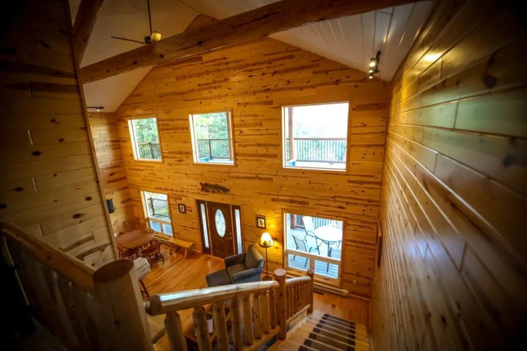 A log cabin with stairs leading up to the second floor.