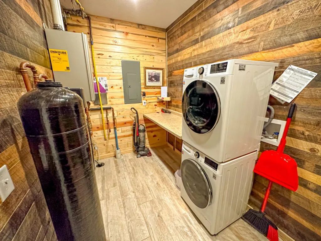 A laundry room with a washer and dryer stacked on top of each other.