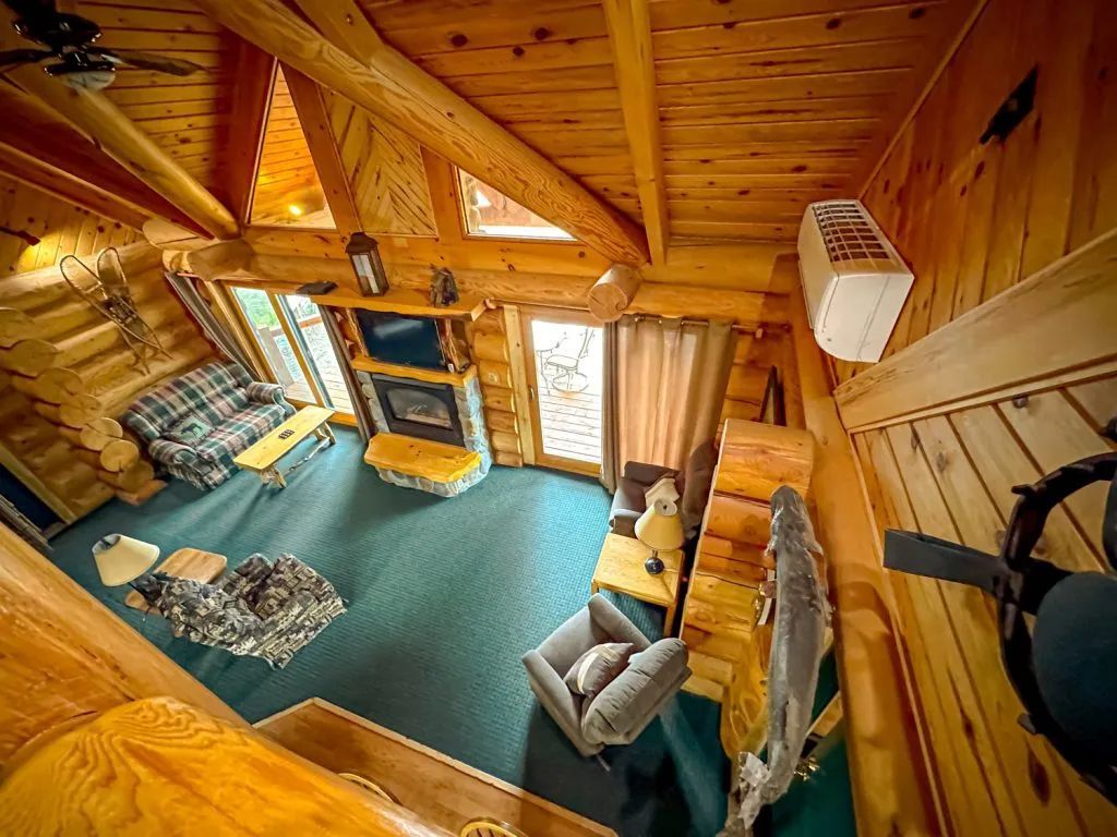 An aerial view of a living room in a log cabin.