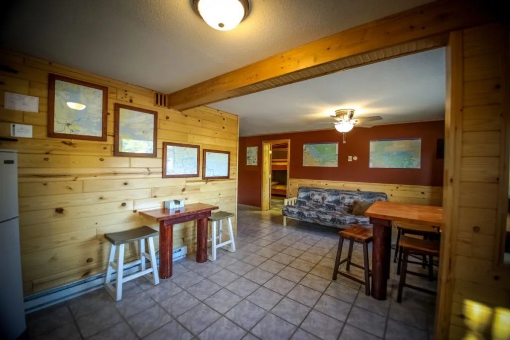 A living room with a couch , table and stools.