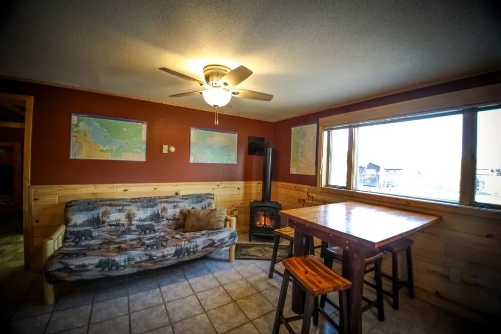 A living room with a couch , table and stools