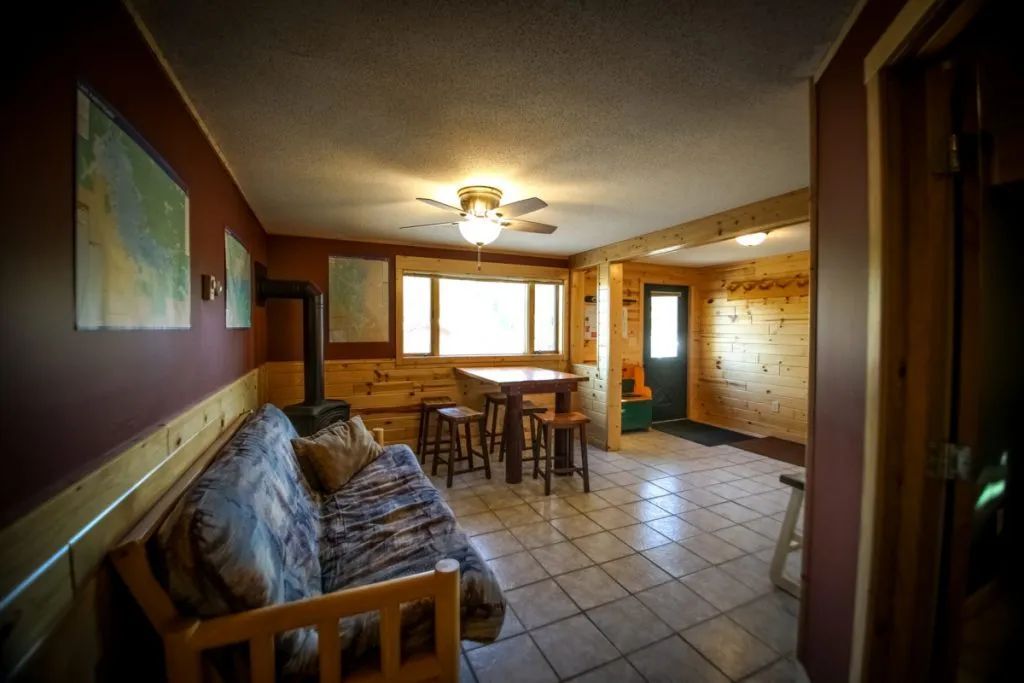 A living room with a couch , table and chairs.