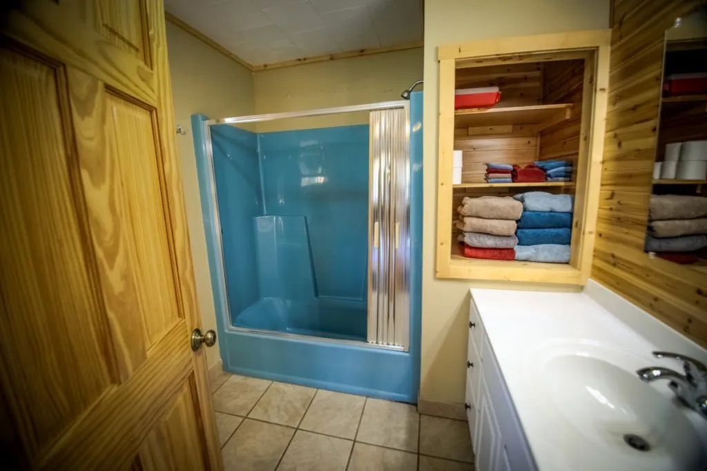 A bathroom with a blue shower and a sink