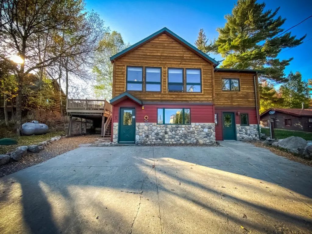 A large house with a lot of windows and a driveway in front of it
