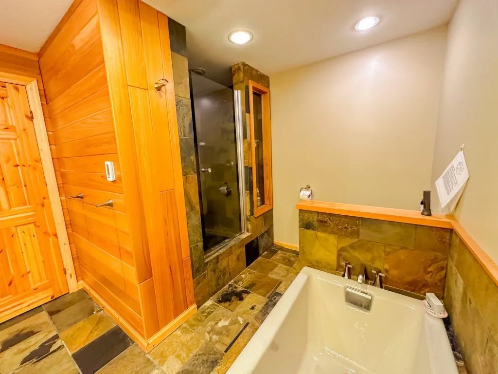 A bathroom with a bathtub and a walk in shower.
