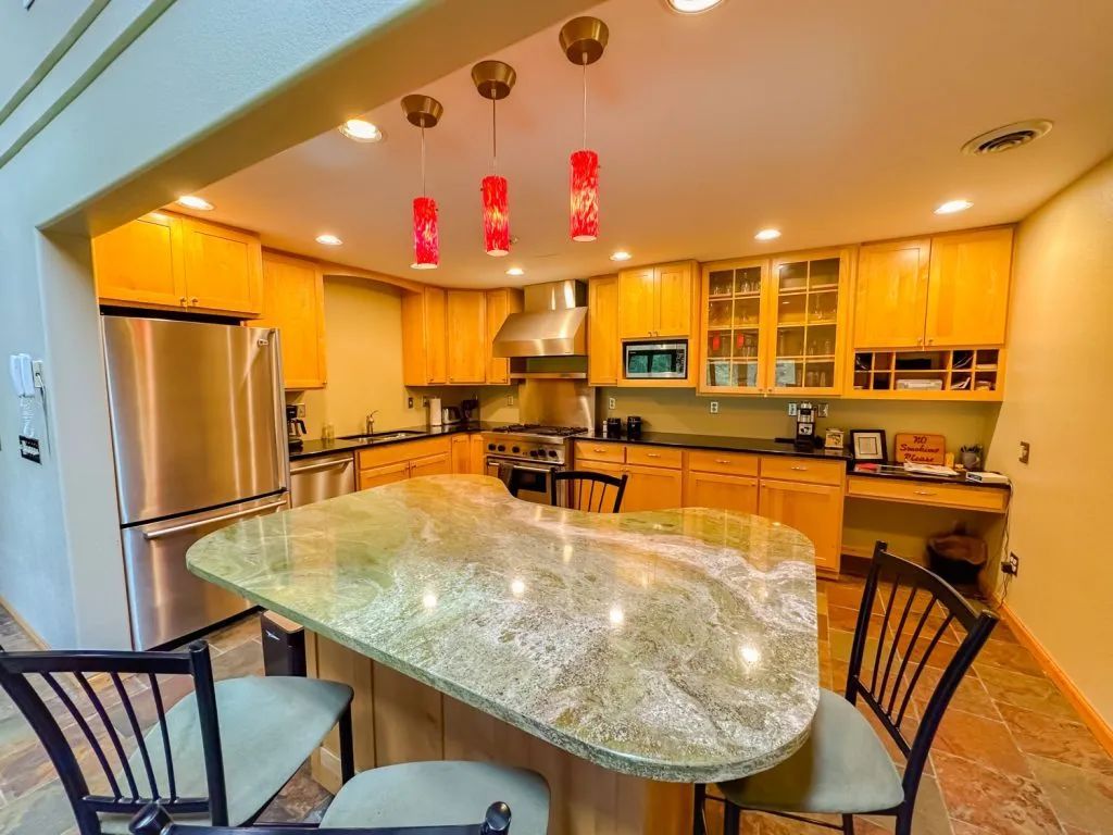 A kitchen with stainless steel appliances and granite counter tops