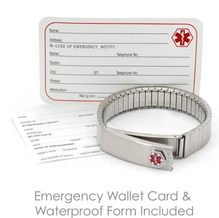 Dog tags on a ball chain, engraved with military information, lying against a cork background.